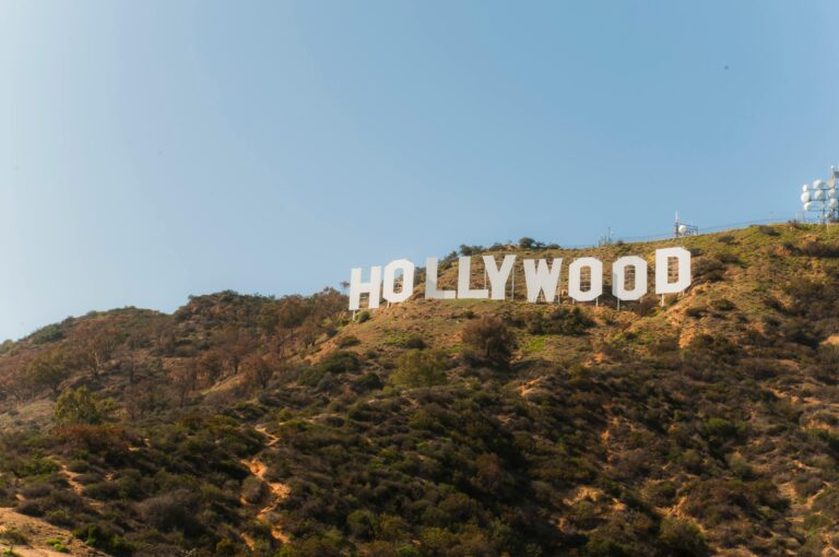 Famous Hollywood Sign on hillside under clear blue sky in Los Angeles, California.