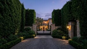 Private gated Beverly Hills estate entrance at dusk representing off-market luxury real estate and seller privacy strategy