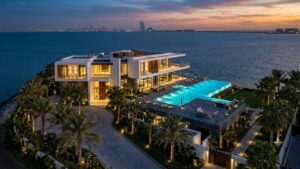 Dubai luxury waterfront villa at dusk — global real estate insight by JB Rugiero The Agency